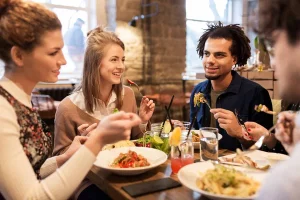 depositphotos 143934019 stock photo happy friends eating and drinking