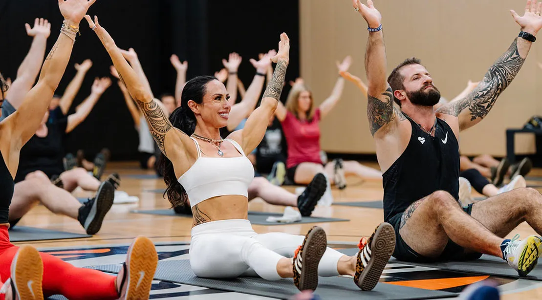 Dr. Gabrielle Lyon leading a group fitness class to stretching.jpg