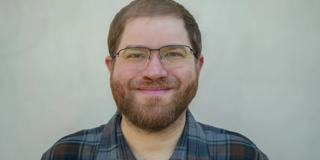 Down Arrow Button Icon 1 Miles Headshot e1768432371276.jpeg