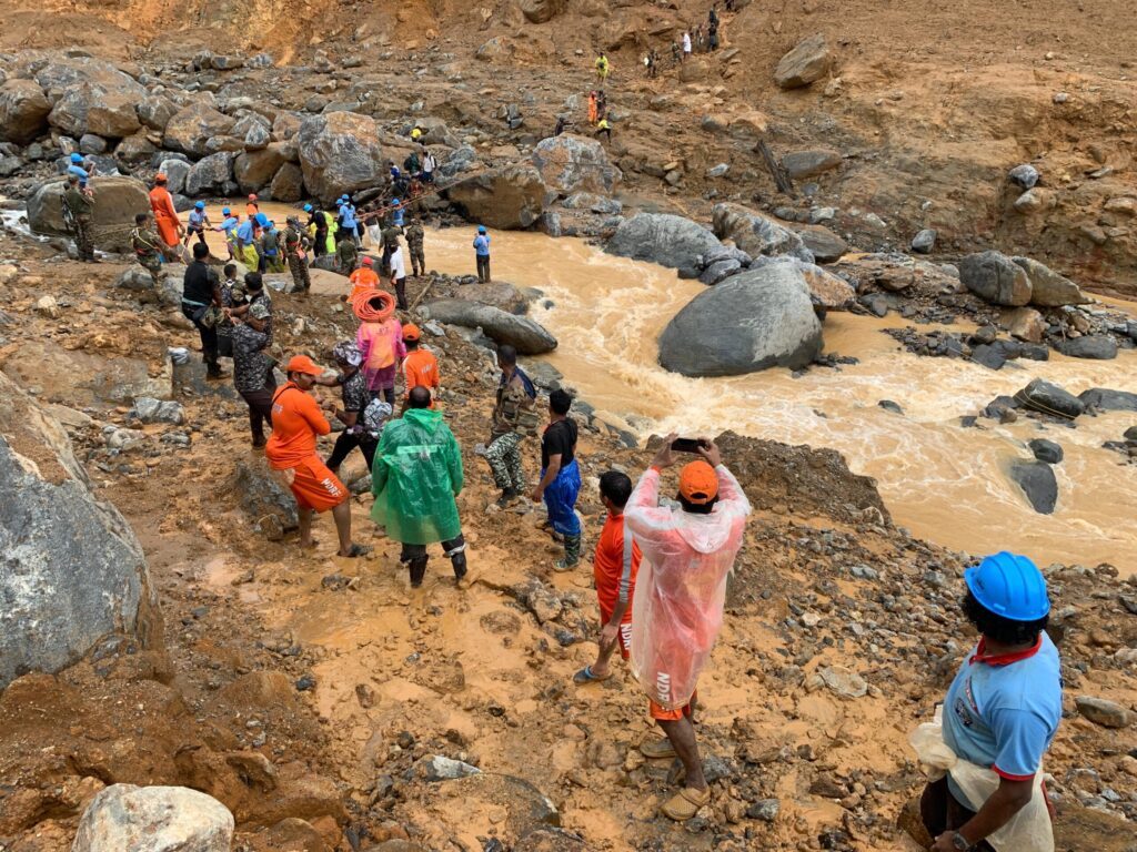 Rescue workers pass through Mundakai and Churalmala landslide area in Wayanad scaled.jpg