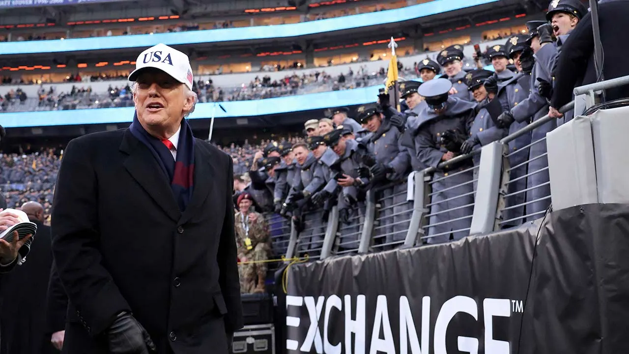 donald trump walks army navy sideline.jpg