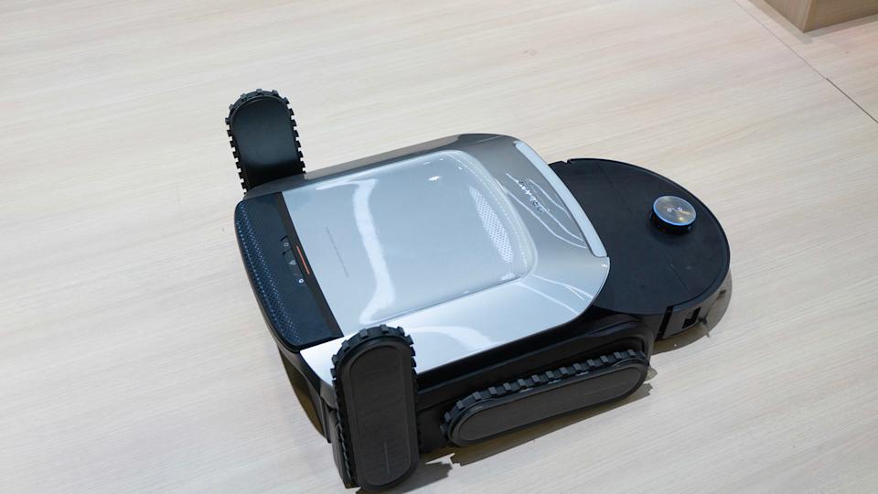 Dreame's latest robot vacuum concept has slightly terrifying legs that can climb full-size stairs 1 dreame cyber x and base.jpg