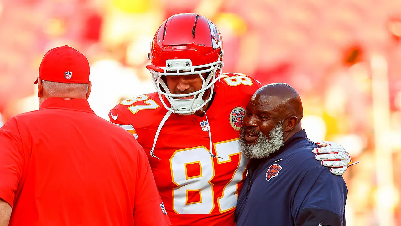 travis kelce and eric bieniemy embrace.jpg