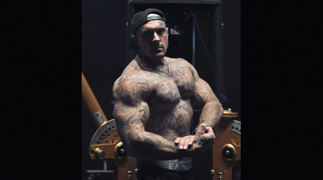 Fitness coach Dane Carter flexing his arm and bicep muscles.jpg
