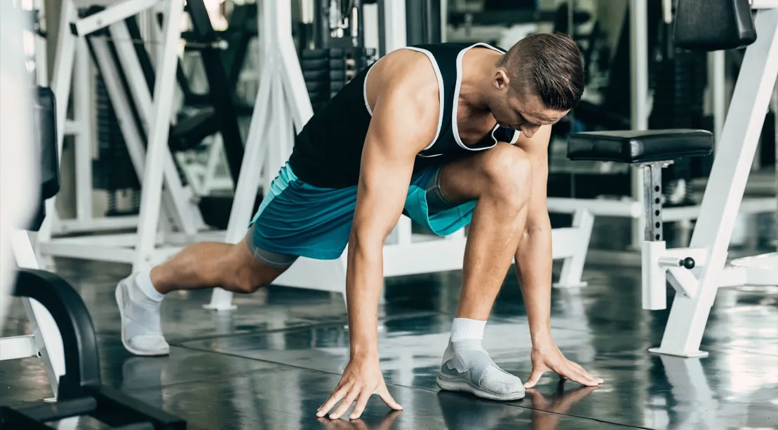 Man Stretching His Hips In The Gym.jpg