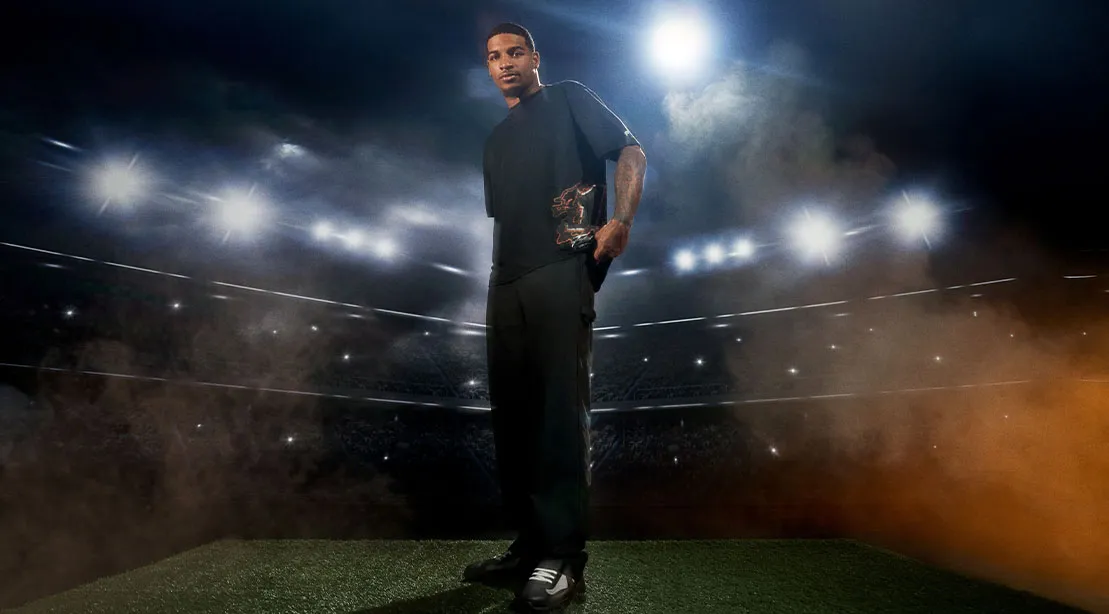 NFL player JaMarr Chase standing in the stadium wearing his new fashion line from Fabletics.jpg