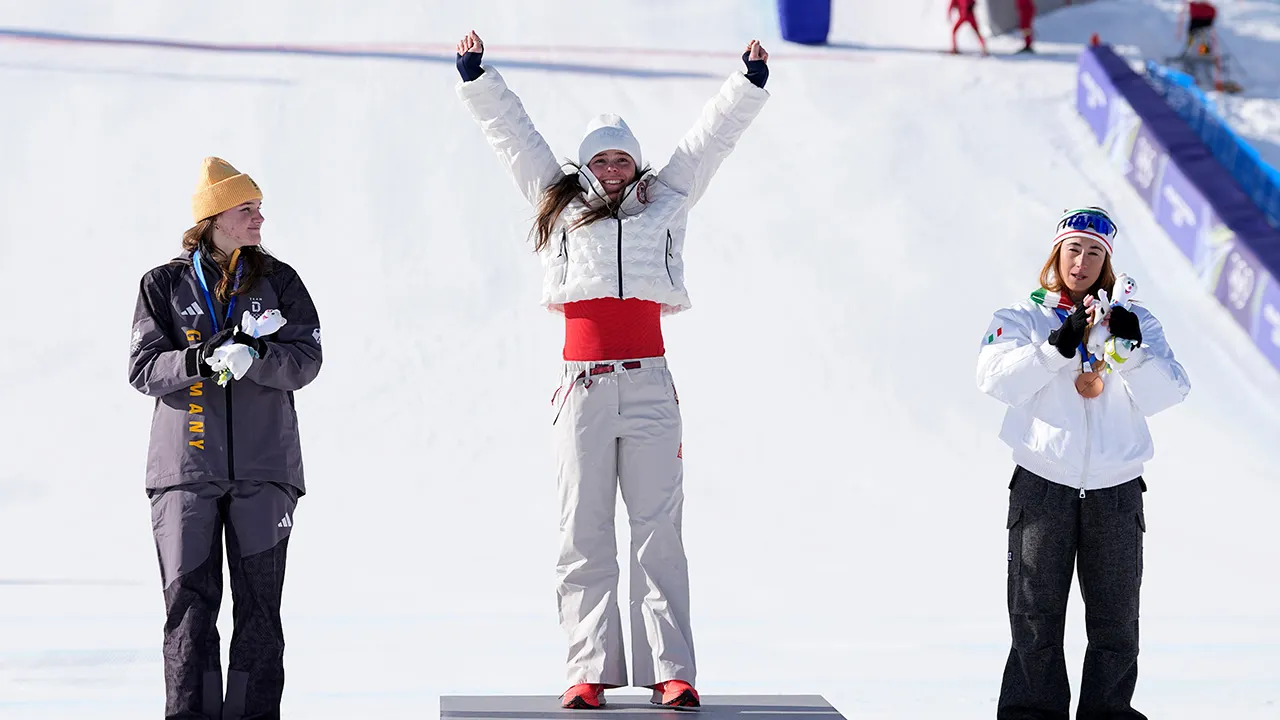 breezy johnson raises arms on podium.jpg