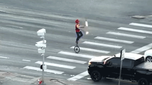 fire juggeler on unicycle.gif
