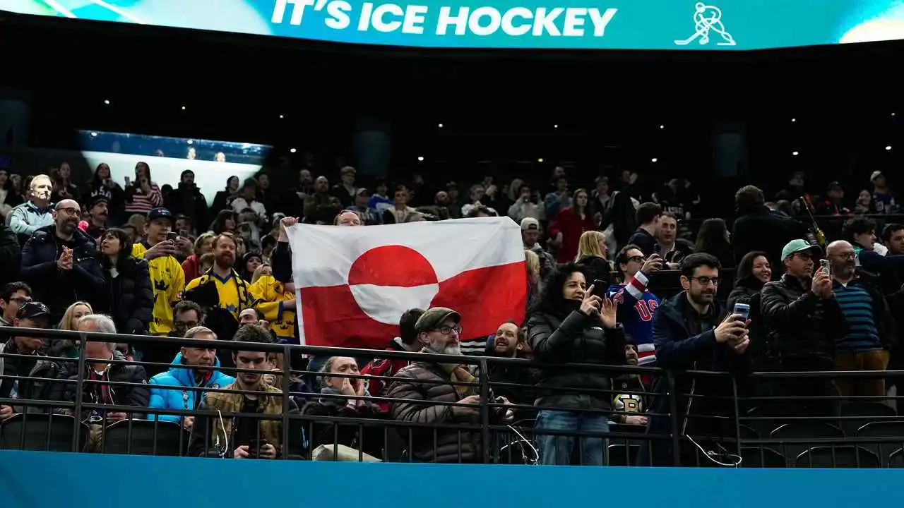 spectators hold greenland flag at winter olympics.jpg