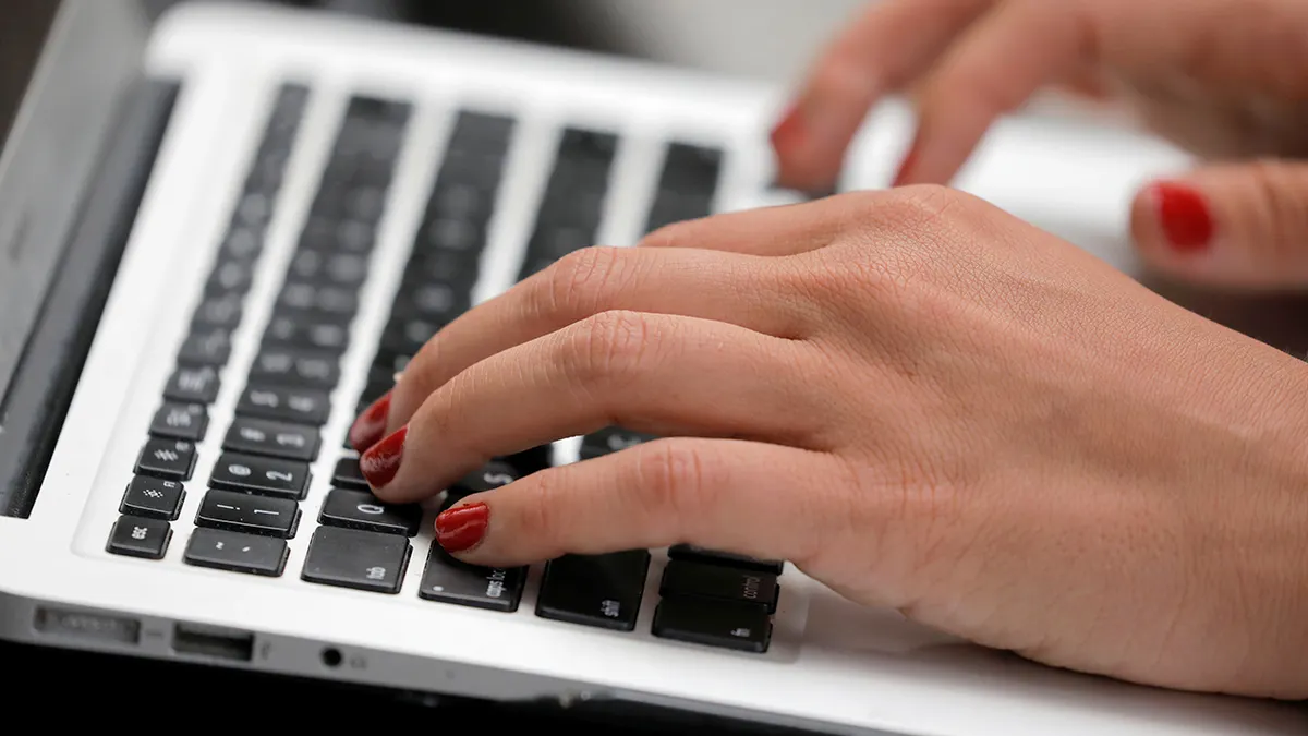 woman types on laptop computer.jpg