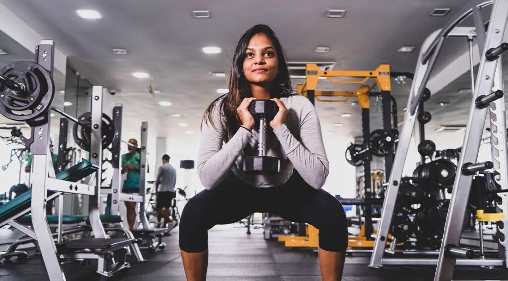 Healthy female performing full body dumbbell workout with a dumbbell goblet squat.jpg