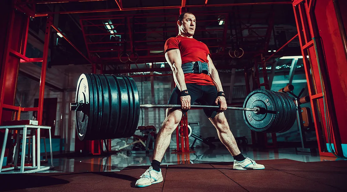 Strong athletic man finishig the sumo deadlift.jpg