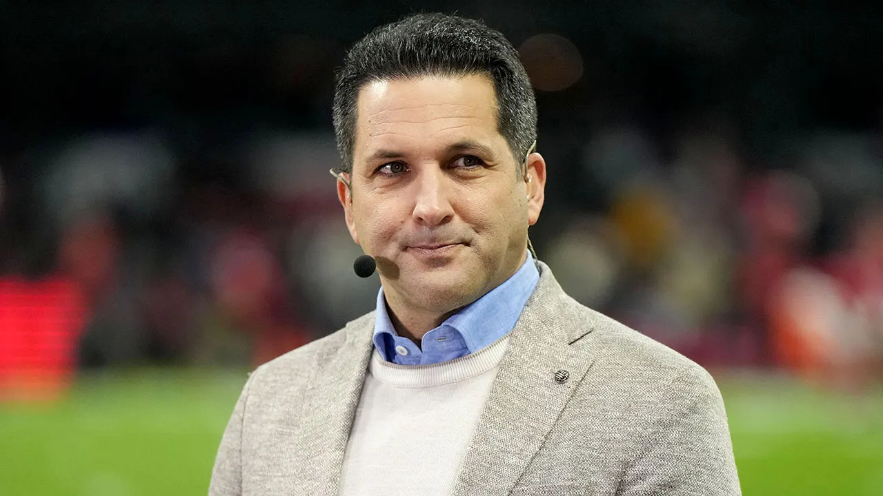 adam schefter looks on espn desk.jpg