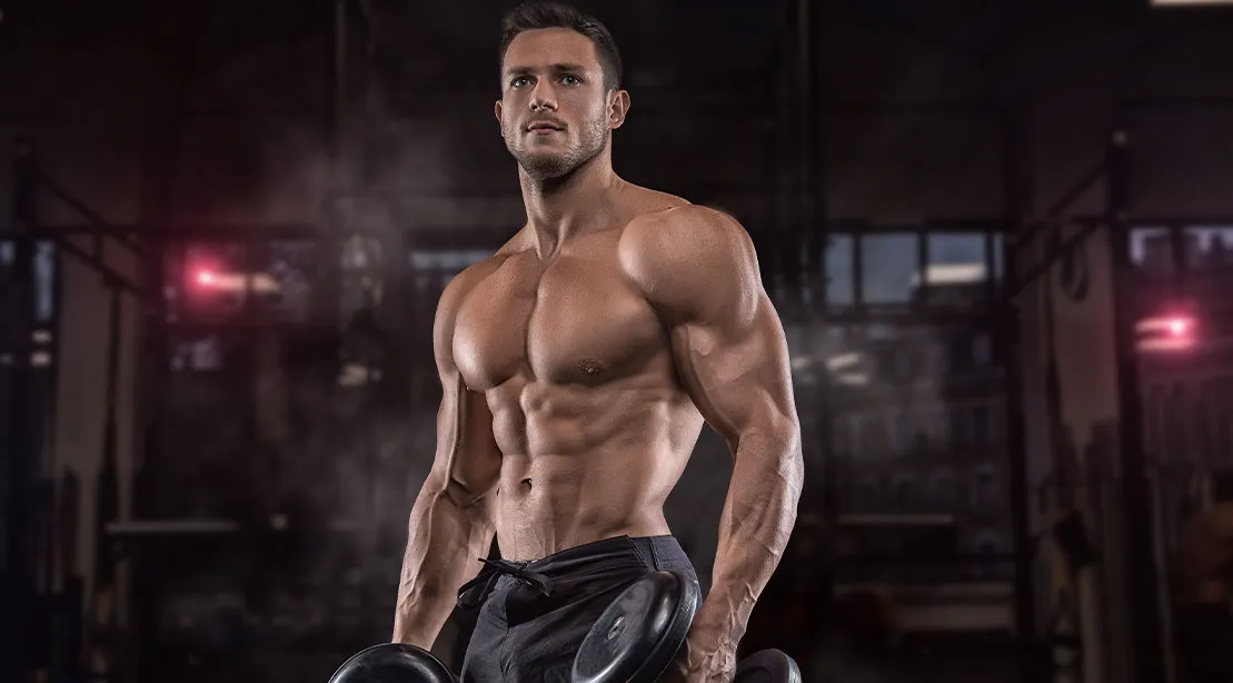 Young muscular athlete using a Science Backed Dropset Strategy to build muscles.jpg