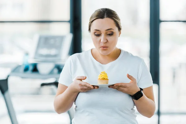 depositphotos 247819240 stock photo overweight woman looking tasty cupcake.webp.webp